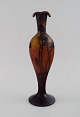 Muller Frères, France. Vase in smoky and dark art glass with carved in the form of branches with ...