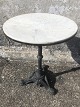 Italian cafe table in marble and black painted iron, appears with a very fine patina and a ...