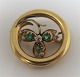 Gold brooch 18K. Not stamped. Presumably Norwegian. With 3 emeralds and 7 small diamonds. ...
