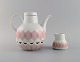Bjørn Wiinblad for Rosenthal. Lotus porcelain service. Teapot with heater for 
tealight candles and creamer decorated with pink lotus leaves. 1980s.
