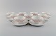 Bjørn Wiinblad for Rosenthal. Lotus porcelain service. 9 teacups with saucers 
decorated with pink lotus leaves. 1980s.
