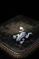 Old brooch in silver in the form of frog with lots of small shiny magazines. Measures: 2,5x2cm.