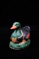 Old Swedish 
piggy bank in 
the form of 
duck in painted 
ceramic.
H:10,5cm. 
L:14cm.