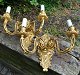 A pair of gilded wall appliques, 20th century France. Each with two light arms. Decorated with ...