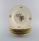 Six Royal Copenhagen Frijsenborg dinner plates in hand-painted porcelain with 
flowers and gold edge. 1950s. 
