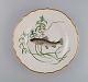 Royal Copenhagen porcelain dinner plate with hand-painted fish motif and golden 
border. Flora / Fauna Danica style. Dated 1968.
