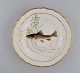 Royal Copenhagen porcelain dinner plate with hand-painted fish motif and golden 
border. Flora / Fauna Danica style. Dated 1951.
