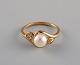 Danish jeweler. Vintage ring in 8 carat gold adorned with cultured pearl and 
clear semi-precious stones. Mid-20th century.
