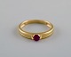 Danish jeweler. Vintage ring in 8 carat gold adorned with red semi-precious 
stone. Mid-20th century.
