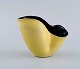 European studio ceramicist. Small unique vase with wavy edge in glazed ceramics. 
Beautiful glaze in yellow shades with black inside. 1960s / 70s.

