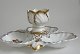 Porcelain 
centerpiece, 
approx. 1900. 
With four 
rooms, 
triangular 
shape, rococo 
pattern. ...