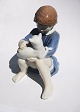 Charming porcelain figure of seated young girl with cat in lap. Designed by John Calster for ...