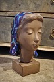 Johannes 
Hedegaard - 
Aluminia, 
stoneware 
woman's head 
with scarf 
glazed in blue. 
Height: 33cm. 
...