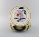 Porcelaine de Paris. "Aurore Tropicale". Six porcelain lunch plates decorated with flowers and ...