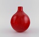 Scandinavian glass artist. Unique vase in red mouth-blown art glass with inlaid bubbles. Late ...
