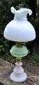 Petroleum lamp, 19th century. White opaline glass base with green glass container with enamel ...