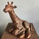 Large reclining 
giraffe of 
unglazed 
stoneware. The 
figure is 
unsigned. 
Appears to have 
been ...