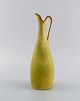 Gunnar Nylund (1904-1997) for Rörstrand. Pitcher in glazed ceramics. Beautiful 
eggshell glaze in light lime shades. Mid-20th century.
