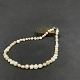 Length 47 cm.Fine pearl necklace with white and pink pearls separated by small flowers in ...
