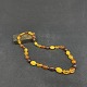 Length 52 cm.Fine necklace with oval amber pearls in the course and different colors.They ...