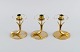 Gunnar Ander for Ystad Metall. Three candlesticks in brass and clear art glass shaped like ...