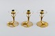 Gunnar Ander 
for Ystad 
Metall. Three 
candlesticks in 
brass and clear 
art glass 
shaped like ...