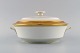 Royal Copenhagen service no. 607. Porcelain lidded tureen. Gold border with 
foliage. Model number 607/9575. Dated 1944.
