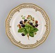 Royal Copenhagen Flora Danica fruit plate in openwork porcelain with 
hand-painted berries and gold decoration. Model number 429/3584. Dated 1968.
