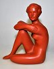 Gmunder pottery of seated woman, 2026. Austria. Stamped. Painted reds. Height.: 12 cm.