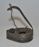 Oil lamp in 
iron tin, 
18/19. thC. 
Samsø, Denmark. 
Heart shaped. 
With chain 
suspension. 7 x 
5 cm. ...