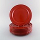 Emile Henry, France. Eight dinner plates in glazed stoneware. Beautiful glaze in 
shades of red. Mid 20th century.
