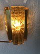 Wall lamp in thick amber colored glass. Height approx. 16 cm. Nice condition.