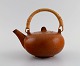 Eva Stæhr-Nielsen for Saxbo. Glazed stoneware teapot with wicker handle. Beautiful glaze in ...