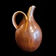 Eva Stæhr-Nielsen for Saxbo;A stoneware pitcher decorated in a brown glaze #64. H. 18,5 cm. ...