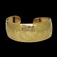 A massive bangle made in 18k gold. Open. Decorated with flowers. Wide 1 cm - 26 cm. Inner ...