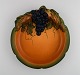 Ipsen's, Denmark. Art nouveau dish in hand-painted ceramics modeled with grape vine and foliage. ...