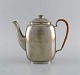 Just Andersen 
(1884-1943), 
Denmark. Art 
deco tin coffee 
pot with wicker 
handle. 1940s. 
Model ...