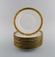 Royal Copenhagen service no. 607. Ten porcelain lunch plates. Gold border with 
foliage. Model number 607/9589. Dated 1960s.
