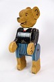 A toy teddy 
bear made of 
wood which has 
acquired a 
patina over the 
years produced 
approx. year 
...