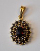 Gilded silver pendant with garnets, 20th century. Stamped. H.: 2.5 cm.Perfect condition!