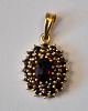 Gilded silver 
pendant with 
garnets, 20th 
century. 
Stamped. H.: 
2.5 cm.
Perfect 
condition!