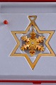 The Christmas Ornament from Georg Jensen. Snow Crystal, gilded brass. Design : Finn Clausen. ...