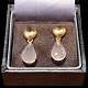 Ole Lynggaard; A pair of heart shaped ear rings in 18k gold, set with rose quartz drops. The ...
