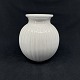 Height 14.5 cm.Beautiful white vase with ribbed outside from L. Hjorth.It is stamped L. ...