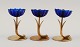 Gunnar Ander 
for Ystad 
Metall. Two 
candlesticks in 
brass and blue 
art glass 
shaped like ...