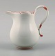 Meissen cream jug in white porcelain with red decoration.Approx. 1930.The jug measures H 12 ...