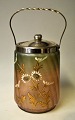 Bisquit bucket, 
approx. 1900. 
Iridescent 
painted glass 
with enamel 
decoration with 
flowers. ...
