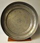 Large pewter dish on base, 18th century. Indistinctly stamped. Engraved: M. Height: 6 cm. Dia.: ...