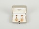 Wallins, 
Sweden.
A pair of 
earrings in 14 
carat gold 
adorned with 
cultured 
pearls.
Dated ...