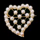 Viggo Wollny; A  heart shaped brooch in 14k gold, set with pearls. H. 3,5 cm. W. 2,2 cm. ...